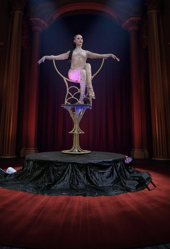 Gold Chair prop with two performers on draped platform