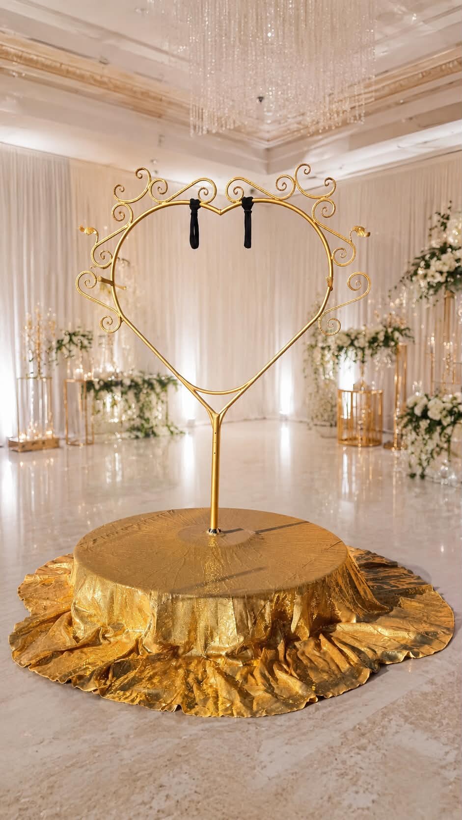 Golden Heart Frame aerial prop on a gold-draped round stage