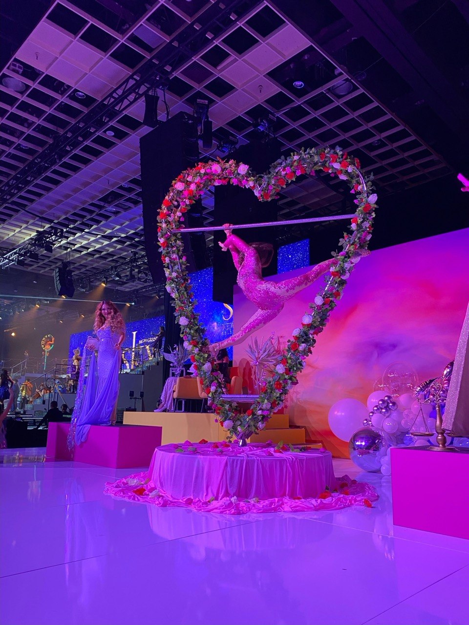 Heart-shaped aerial prop with flowers and performer, Las Vegas event