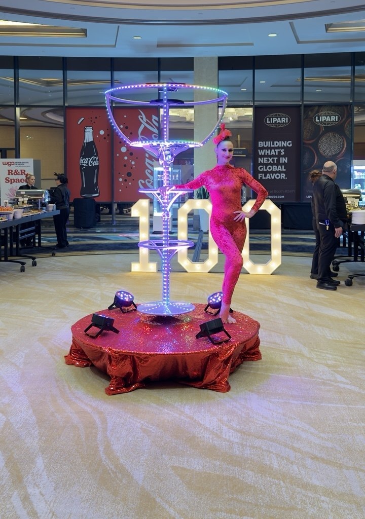 Giant LED martini glass act with a performer at a Las Vegas event